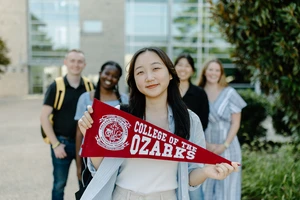 Students holding College of the Ozarks banner